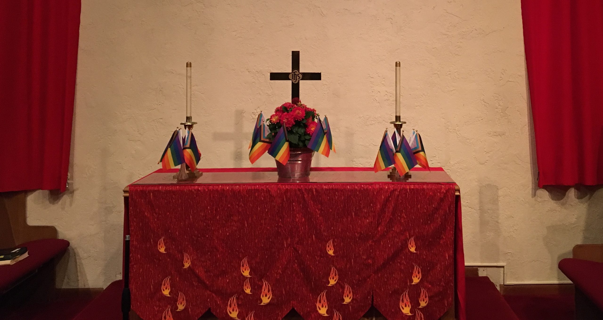 Haller Lake UMC altar in red for pentecost with pride flags